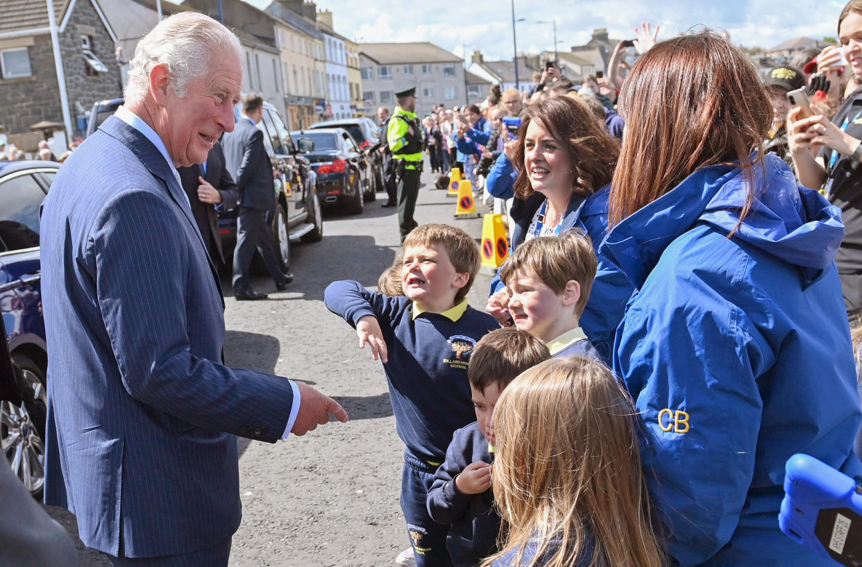 BANGOR, NORTHERN IRELAND - MAY 19: Prince Charles, Prince of Wales meets wellwishers as he arrives to view stones which line the Donaghadee Harbour walls and were decorated with messages of hope by local people during the pandemic on May 19, 2021 in Bangor, Northern Ireland. (Photo by Samir Hussein - Pool/WireImage)