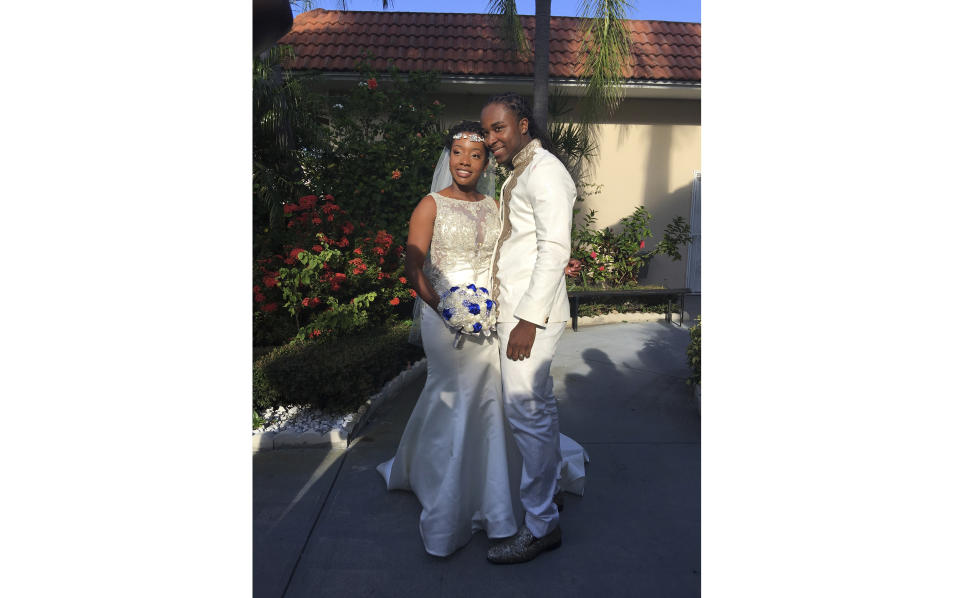 In this Nov. 9, 2018 photo provided by Nikese Toussaint, Jean-Dickens Toussaint and his wife Abigail Michael Toussaint pose for a photo at their wedding in Pompano Beach, Florida. Nikese Toussaint says that gangs in Haiti kidnapped the U.S. couple and a third person traveling with them on March 18, and that the gang is demanding $200,000 for each person. (Nikese Toussaint via AP)