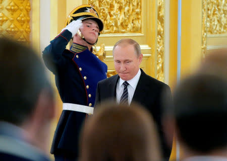 Russian President Vladimir Putin enters a hall during an awarding ceremony for Russian Olympic medallists returning home from the 2016 Rio Olympics, at the Kremlin in Moscow, Russia August 25, 2016. REUTERS/Maxim Shemetov