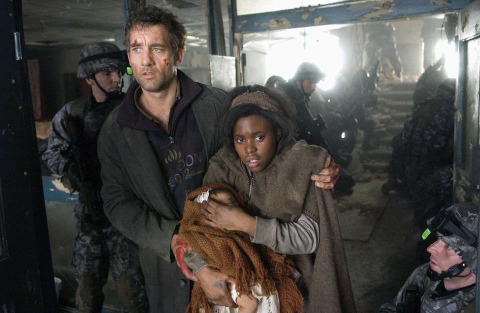 A beaten man and a young woman with her baby walk past a line of soldiers