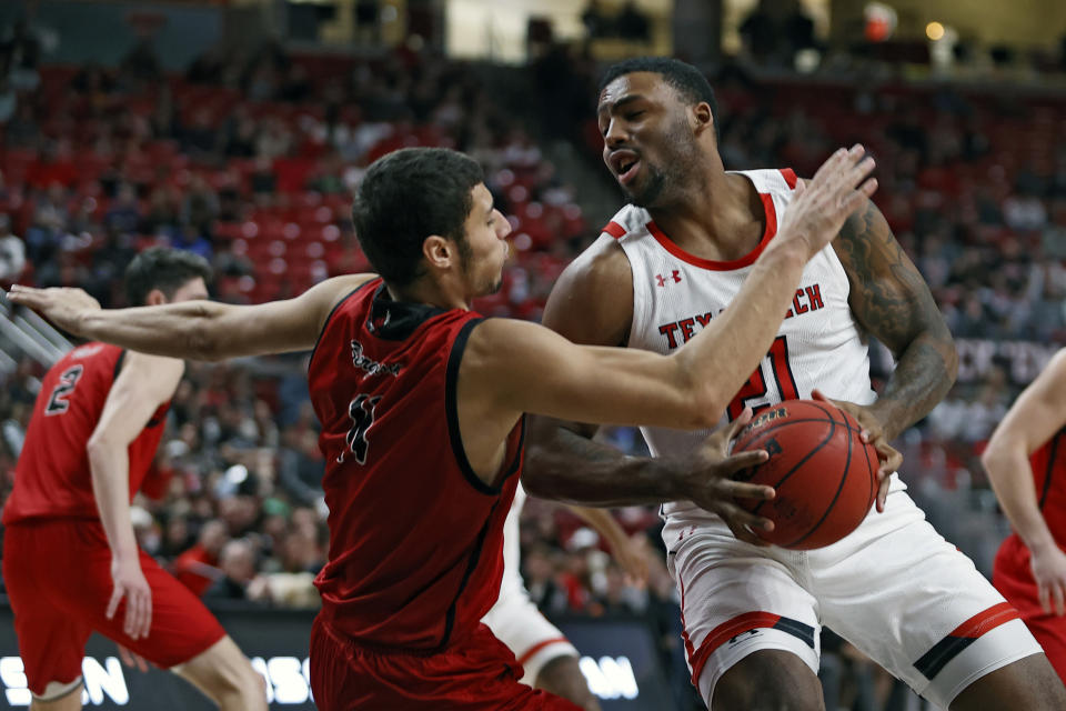 Texas Tech's KJ Allen (21) charges Eastern Washington's Rylan Bergersen (11) during the second half of an NCAA college basketball game on Wednesday, Dec. 22, 2021, in Lubbock, Texas. (AP Photo/Brad Tollefson)