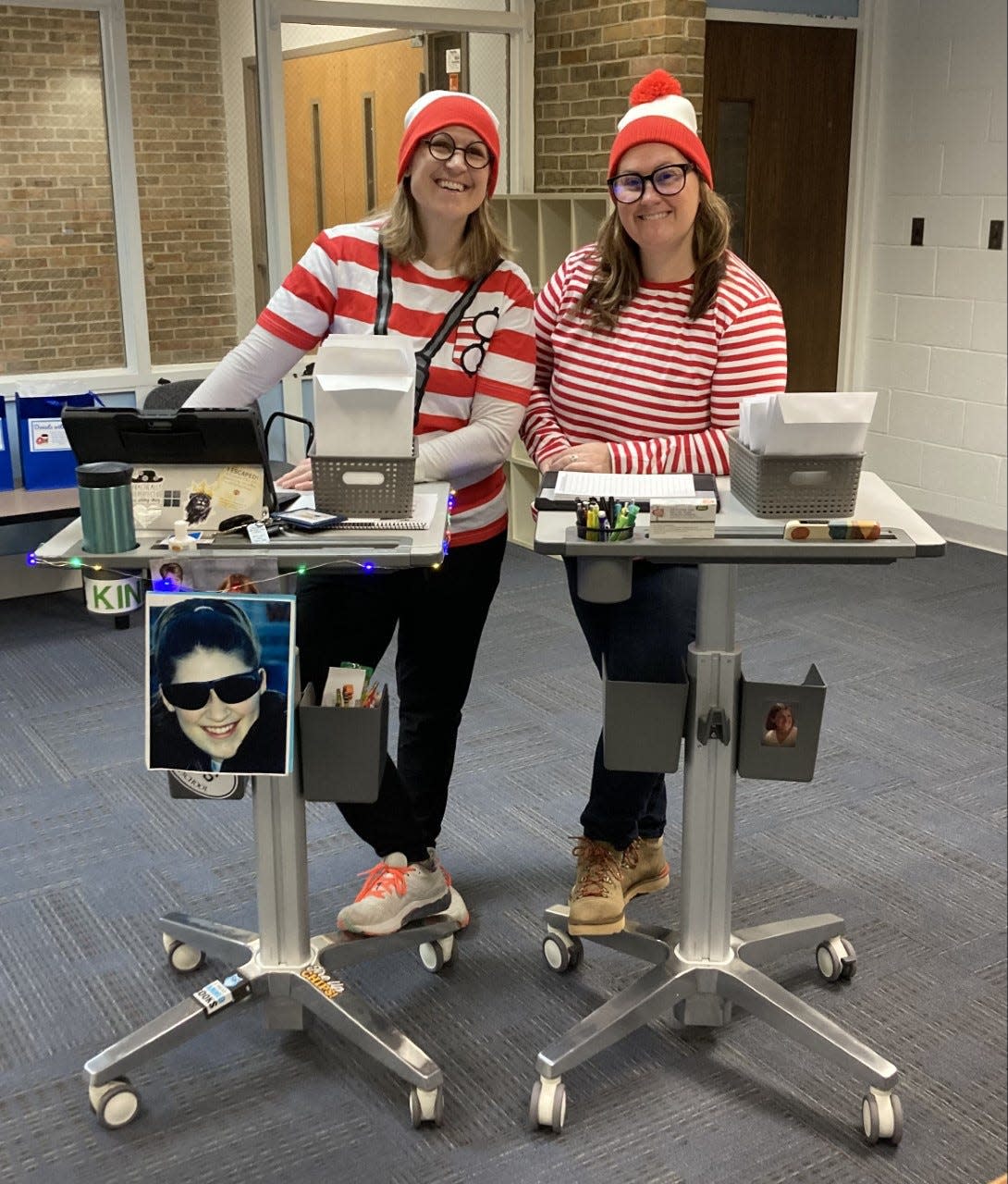 Teachers Samantha Fettig (left) and Jamie Whitley (right) dress as Wenda from the "Where's Waldo?" series for Way Back Wednesday at Petoskey High School. On Wednesdays, faculty dress as Waldo or Wenda and students can find them to voluntarily give them their cell phones. Their phones are kept in the office throughout the day.