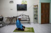 Rohingya refugee and activist Zafar Ahmad Abdul Ghani prays at his home in Kuala Lumpur