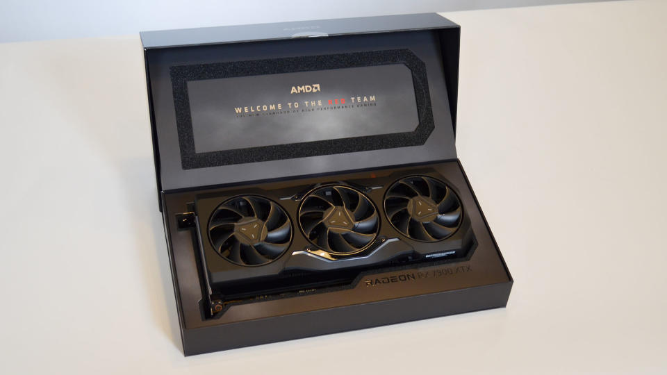 An AMD Radeon RX 7900 XTX on a table against a white backdrop