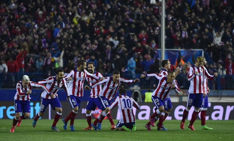 Atletico Madrid's players celebrate after wining the UEFA Champions League football match Club Atletico de Madrid vs Bayer Leverkusen in Madrid on March 17, 2015