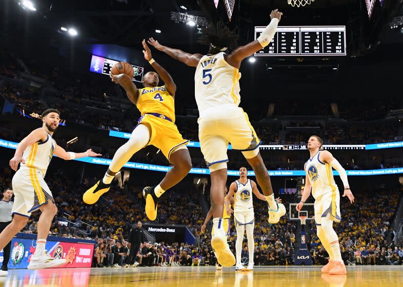 San Francisco, California May 10, 2023-Lakers Lonnie Walker scores a basket over Warriors Kevon Looney in the second half in Game 5 of the NBA playoff series at Chase Center Wednesday. (Wally Skalij/Los Angeles Times)