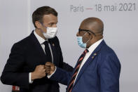 French President Emmanuel Macron salutes Comoros' President Azali Assoumani at the Summit on the Financing of African Economies Tuesday, May 18, 2021 in Paris. More than twenty heads of state and government from Africa are holding talks in Paris with heads of international organizations on how to revive the economy of the continent, deeply impacted by the consequences of the COVID-19 pandemic. (Photo by Ludovic Marin, Pool via AP)