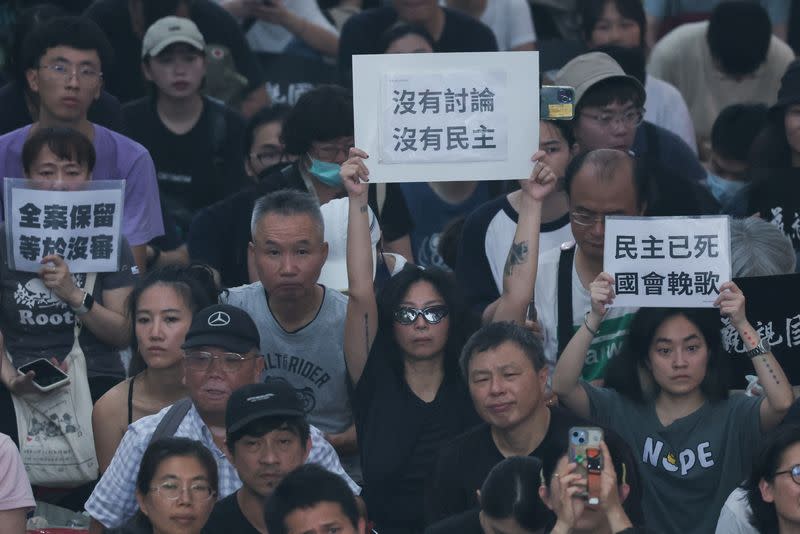 People gather outside the parliament during parliamentary session in Taipei