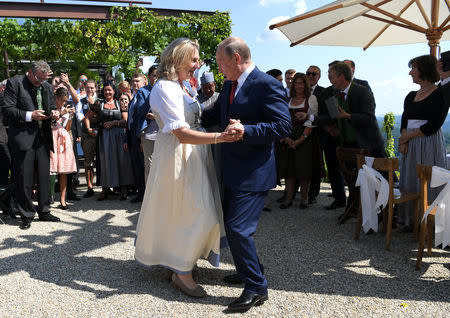 Austria's Foreign Minister Karin Kneissl dances with Russia's President Vladimir Putin at her wedding in Gamlitz, Austria, August 18, 2018. Roland Schlager/Pool via Reuters