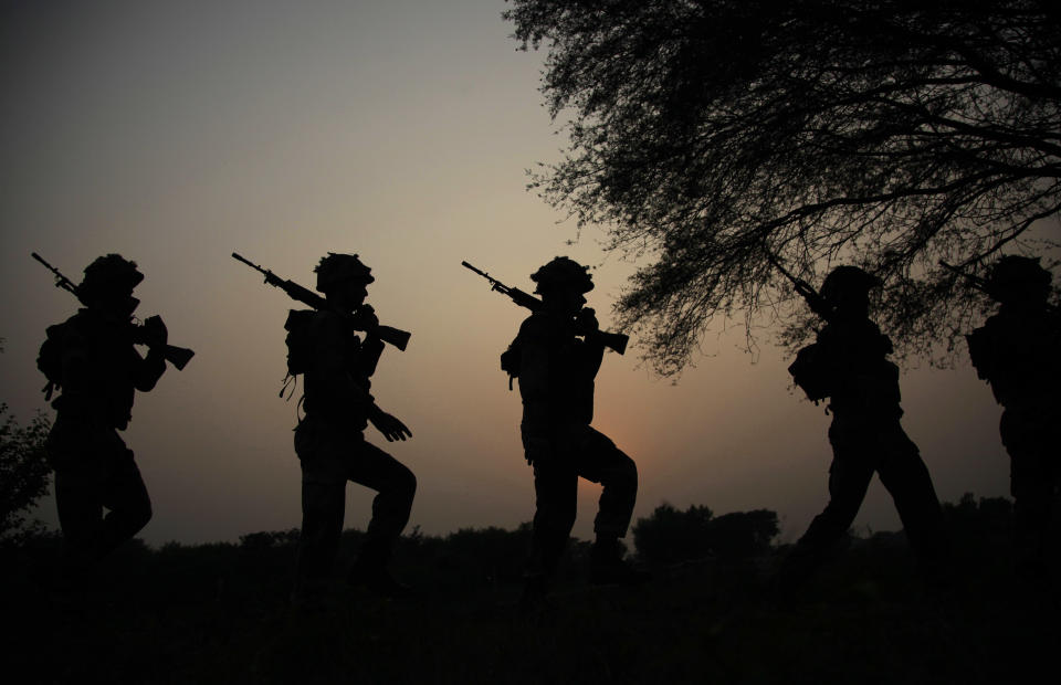 FILE - In this Oct. 2, 2016 file photo, Indian army soldiers patrol near the Line of Control in Nowshera sector, about 90 kilometers from Jammu, India. As India considers its response to the suicide car bombing of a paramilitary convoy in Kashmir that killed dozens of soldiers on Feb. 14, 2019, a retired military commander who oversaw a much-lauded military strike against neighboring Pakistan in 2016 has urged caution. (AP Photo/Channi Anand, File)