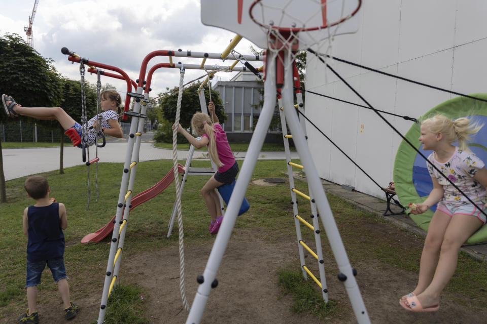 Ukrainian refugee children play on a playground at a refugee shelter in Warsaw, Poland, Wednesday, Aug. 17, 2022. As Russia’s war against Ukraine reaches the sixth-month mark, many refugees are coming to the bitter realization that they will not be returning home soon. With shelling around a nuclear power plant and missiles threatening even western regions of Ukraine, many refugees don’t feel safe at home, even if those areas are under Ukrainian control. (AP Photo/Michal Dyjuk)