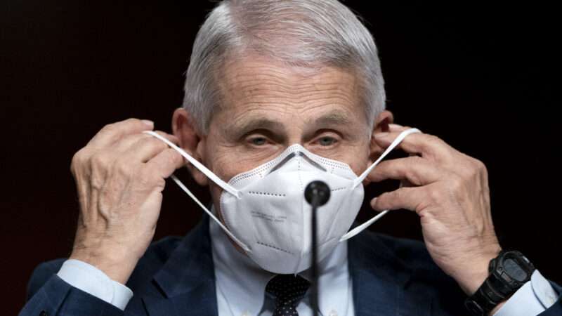 Dr. Fauci puts on a mask