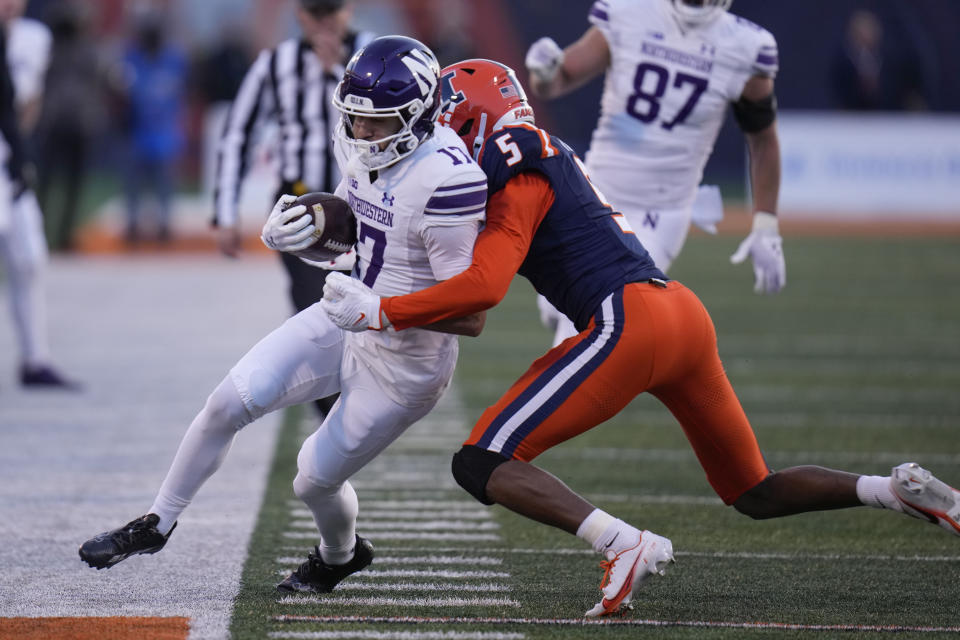 Northwestern wide receiver Bryce Kirtz, left, is forced out of bounds by Illinois defensive back Zachary Tobe during the first half of an NCAA college football game Saturday, Nov. 25, 2023, in Champaign, Ill. (AP Photo/Erin Hooley)