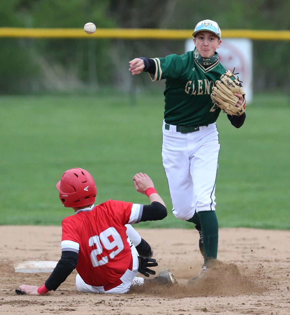 Alex Laird of GlenOak gets AJ Pierson of Canton South out at second base before throwing to first to complete the double play during their game at Canton South on Friday, April 16, 2021.