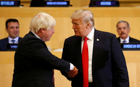 U.S. President Donald Trump shakes hands with British Foreign Secretary Boris Johnson (L) as they take part in a session on reforming the United Nations at U.N. Headquarters in New York, U.S., September 18, 2017. REUTERS/Kevin Lamarque