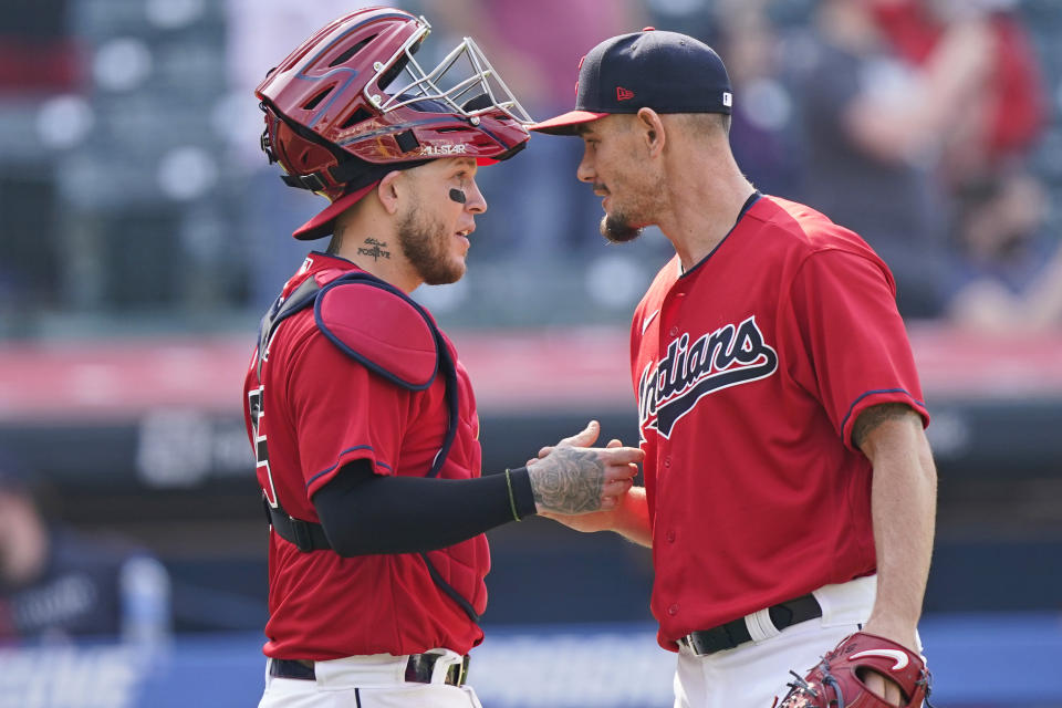 Cleveland Indians relief pitcher Nick Wittgren, right, is congratulated by catcher Roberto Perez after the Indians defeated the Kansas City Royals 4-2 in a baseball game, Wednesday, April 7, 2021, in Cleveland. (AP Photo/Tony Dejak)