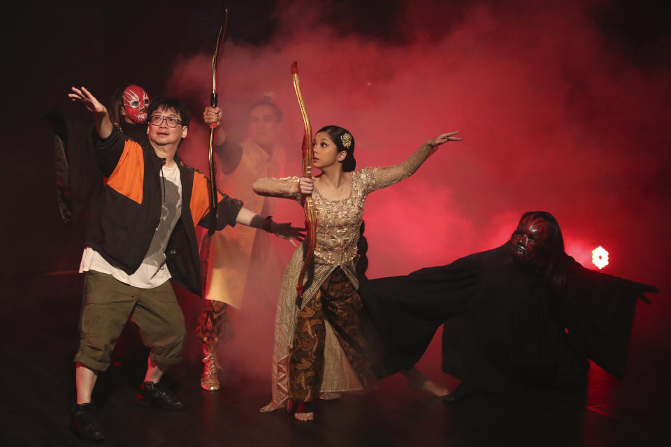 Indonesian choreographer Rusdy Rukmarata, left, directs dancers Nala Amyrtha, center, and Siswanto "Kojack" Kodrata, second from left, as they perform during a video recording for '"Saweran Online" program on Indonesia Dance Network YouTube channel, at EKI Dance Company studio in Jakarta, Indonesia Thursday, May 14, 2020. Rukmarata and another coreographer, Yola Yulfianti, are helping fellow dancers who lost their jobs due to the new coronavirus outbreak in the country by setting up the YouTube channel as a platform where dancers, choreographers and dance teachers can perform, then receive donation from viewers. (AP Photo/Achmad Ibrahim)