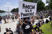 Priscilla Duerrero from Boston, currently living in Washington, D.C., attends the March on Washington, Friday, Aug. 28, 2020, at the Lincoln Memorial in Washington, on the 57th anniversary of the Rev. Martin Luther King Jr.'s "I Have A Dream" speech. (AP Photo/Julio Cortez)