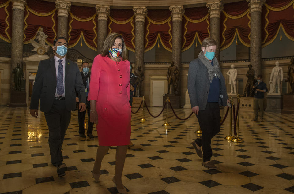 House Speaker Nancy Pelosi walks towards the House Chamber at the Capitol, Monday, July 20, 2020, in Washington. Pelosi, who presided over a moment of silence for Georgia Rep. John Lewis, choked up Monday recalling their last conversation the day before he died. “It was a sad one,” Pelosi said of their conversation Thursday. “We never talked about his dying until that day.” Lewis, 80, died Friday, several months after he was diagnosed with advanced pancreatic cancer. (AP Photo/Manuel Balce Ceneta)