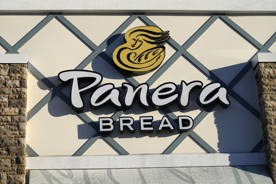 FILE - A Panera Bread logo is attached to the outside of a Panera Bread restaurant location, Tuesday, Dec. 20, 2022, in Westwood, Mass. Greg Flynn, a wealthy campaign donor of California Gov. Gavin Newsom, said the Panera Bread restaurants he owns will start paying workers at least $20 an hour on April 1 after controversy over whether a new state minimum wage law for fast food workers applies to his businesses. (AP Photo/Steven Senne,File)