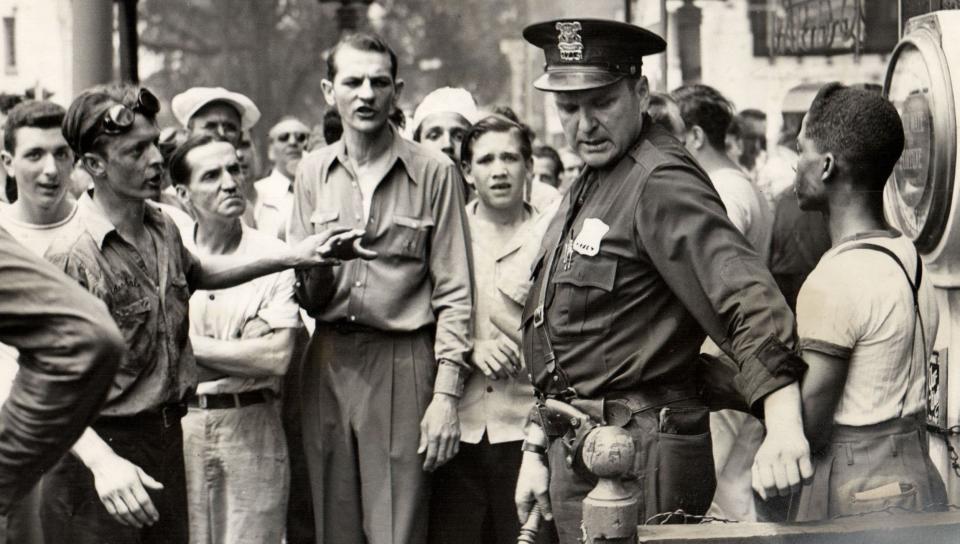 A police officer stands in front of a Black man during the 1943 race riot. Historian Thomas Sugrue described the events in June 1943 as “one of the worst riots in 20th century America.”