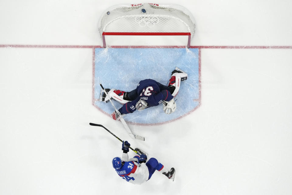 Slovakia's Peter Cehlarik (34) scores the winning goal past United States goalkeeper Strauss Mann (31) during a shoot-out in a men's quarterfinal hockey game at the 2022 Winter Olympics, Wednesday, Feb. 16, 2022, in Beijing. Slovakia won 3-2. (AP Photo/Matt Slocum)