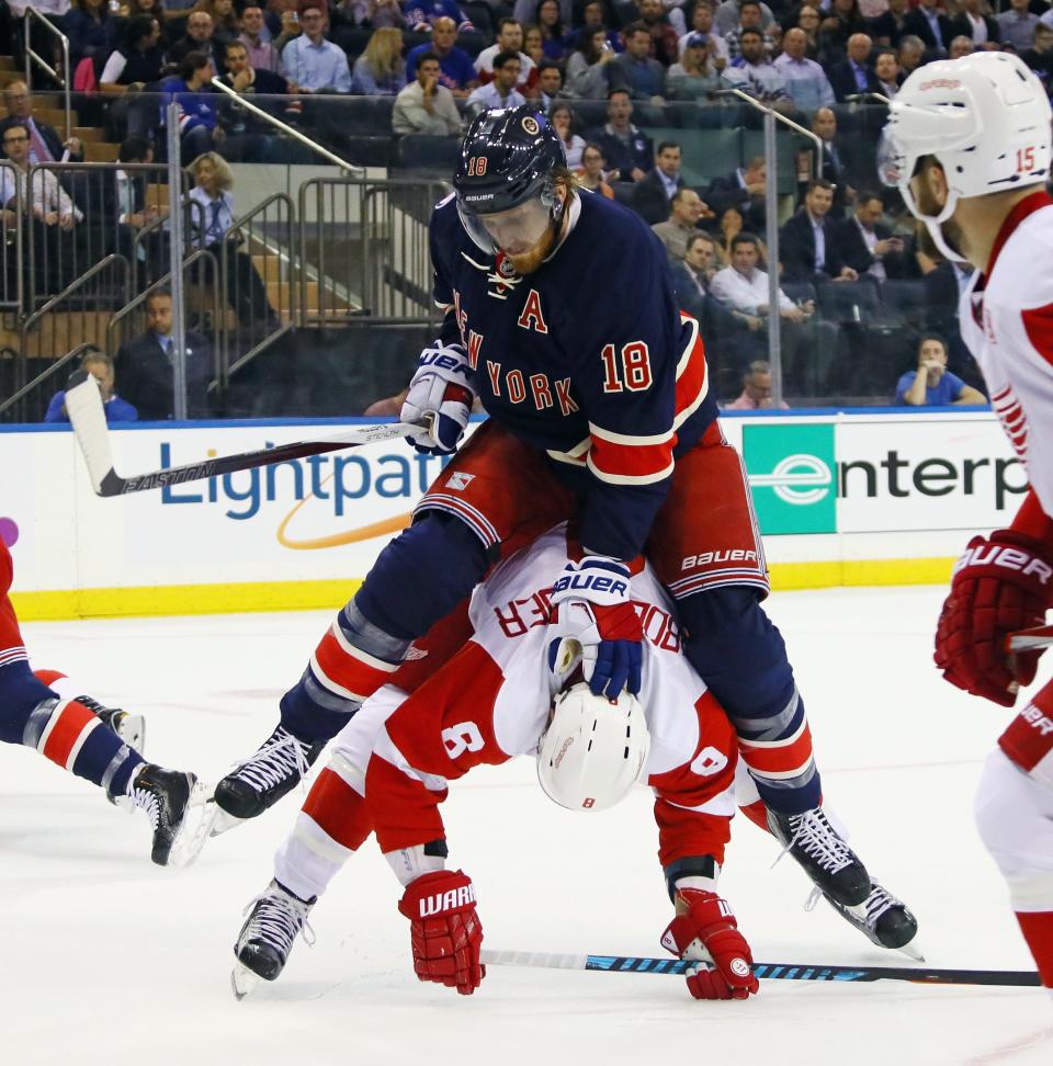 Marc Staal of the New York Rangers holds down Justin Abdelkader of the Detroit Red Wings during the first period at Madison Square Garden on Oct. 19, 2016 in New York City.