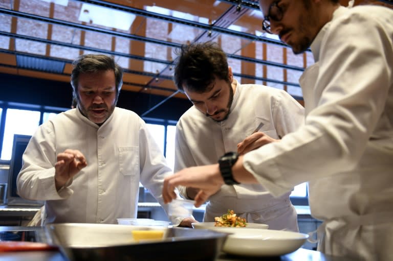 Michel Troisgros (L) cooks with his sons Cesar (R) and Leo in the new Troisgros restaurant, a veritable shrine to France's haute cuisine