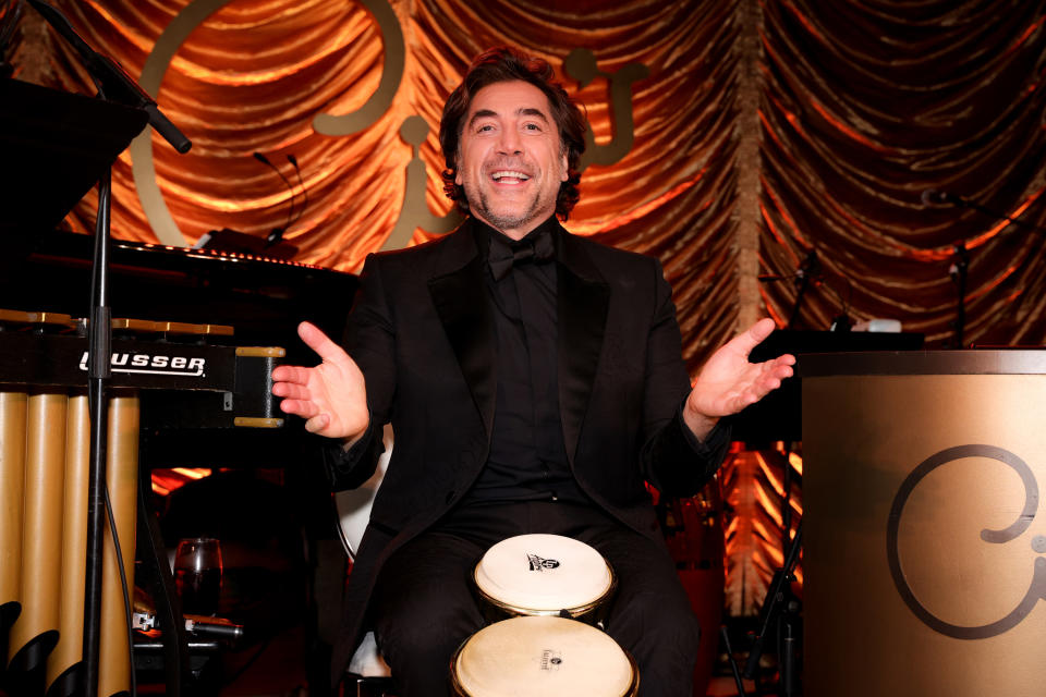 Javier smiles while playing the bongos at the movie premiere party