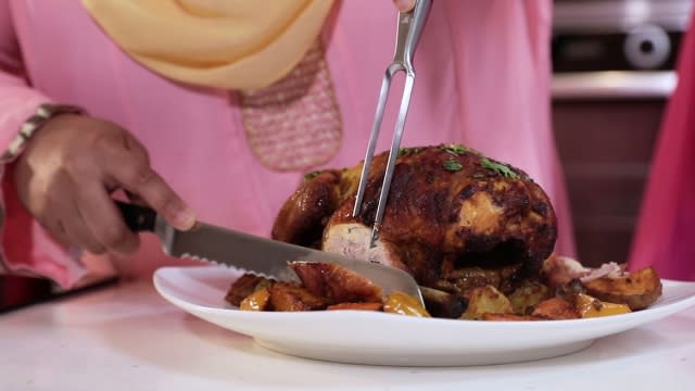 slice the roasted whole chicken with a knife