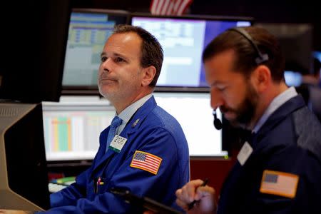 Traders work on the floor of the New York Stock Exchange (NYSE) shortly after the opening bell in New York, U.S., July 5, 2016. REUTERS/Lucas Jackson