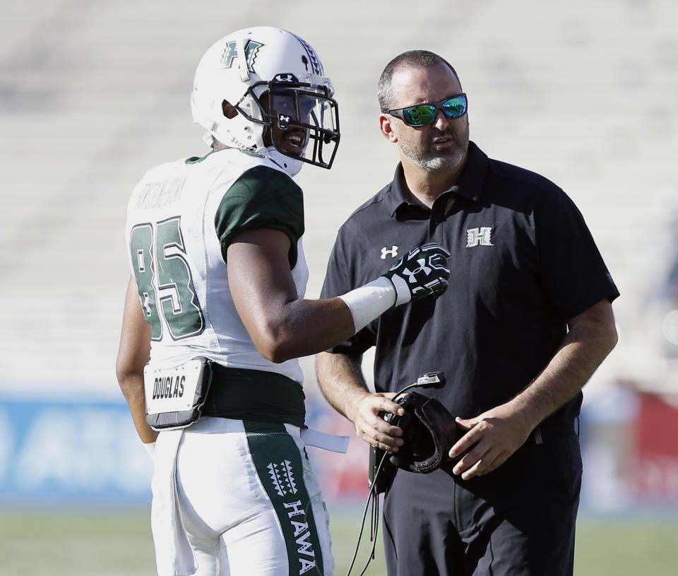 Hawaii wide receiver Marcus Armstrong-Brown, left, talks with head coach Nick Rolovich during the second half of an NCAA college football game against UCLA in Pasadena, Calif., Saturday, Sept. 9, 2017. UCLA won 56-23. (AP Photo/Alex Gallardo)