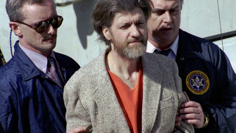 Theodore “Ted” Kaczynski is flanked by federal agents as he is led to a car from the federal courthouse in Helena, Mont., April 4, 1996. A spokesperson for the Bureau of Prisons on Saturday, June 10, 2023, told The Associated Press that Kaczynski, known as the “Unabomber,” has died in federal prison.