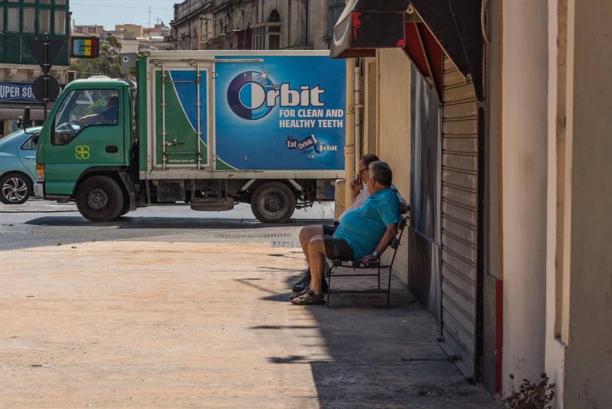 Two men observing the chewing gum truck