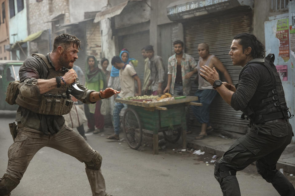 This image released by Netflix shows Chris Hemsworth, left, in a scene from "Extraction," premiering this week on Netflix. (Jasin Boland/Netflix via AP)