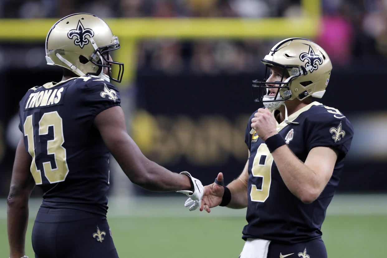 New Orleans Saints quarterback Drew Brees (9) greets wide receiver Michael Thomas (13) after a touchdown. (AP Photo/Bill Feig)