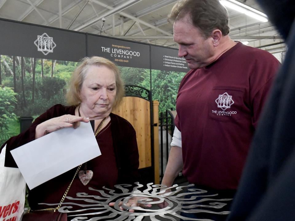 Lynda Blankenship, of Massillon, talks with Gary Hoyt of Levengood Company at Stark County Home & Garden Show.