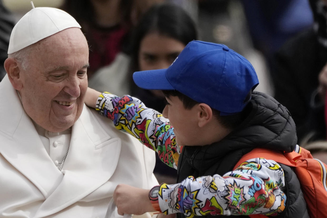 Pope Francis hugs a child at the end of his weekly general audience in St. Peter's Square, at the Vatican, Wednesday, March 29, 2023. (AP Photo/Alessandra Tarantino)
