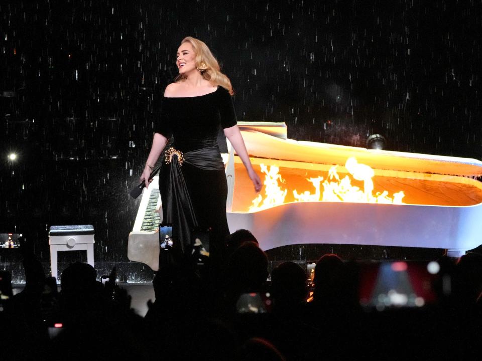 Adele performs in front of a piano set on fire  during the "Weekends with Adele" Residency Opening at The Colosseum at Caesars Palace on November 18, 2022 in Las Vegas, Nevada.