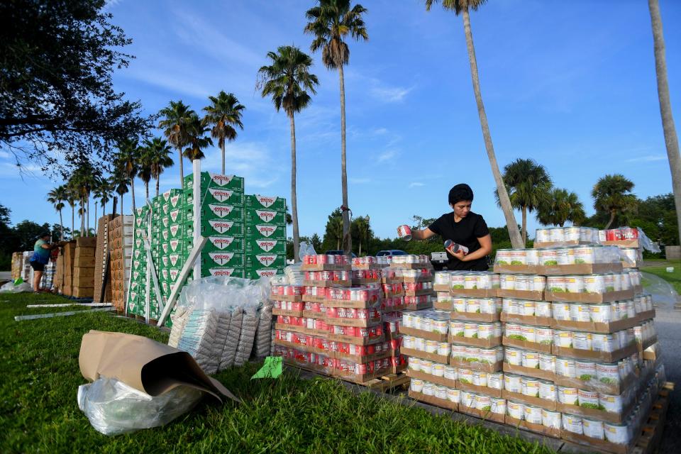 Sonia Aguilar, of Fellsmere, volunteers with Treasure Coast Food Bank’s monthly mobile pantry outside of Revelation Truth Church,100 Mesa Park Blvd., Wednesday, Aug. 9, 2023, in Fellsmere. Participants arrived to get in line with open trunks a couple of hours before the food, donated from national grocery and retail stores, was dispersed. To participate in the distribution, you must fill out a form noting your household size, address and yearly gross income for each family size.