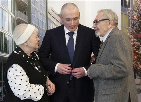 Freed Russian former oil tycoon Mikhail Khodorkovsky stands with his parents Marina and Boris ahead of a news conference in the Museum Haus am Checkpoint Charlie in Berlin, December 22, 2013. REUTERS/Michael Kappeler/Pool