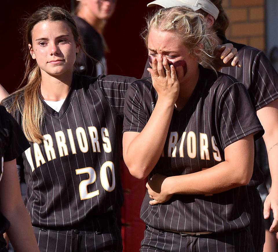 Watkins Memorial seniors Emma Janiszewski (20) and Hannah Hunt comfort each other after the Warriors fell to Holland Springfield 4-2 in the Division I state semifinal on Thursday, June 2, 2022 at Firestone Stadium in Akron.