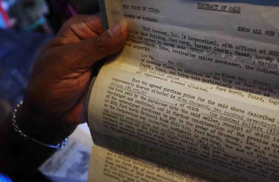 Ruby Clark holds the contract of sale for the home her parents, Herman and Juanita Watson, purchased in 1953 in the Greenway neighborhood. Clark grew up in the neighborhood and now lives in the home.