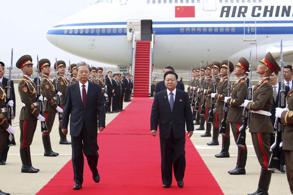 Choe Ryong Hae, center right, vice-chairman of the central committee of the Workers' Party of North Korea, escorts Zhao Leji, center left, chairman of the National People’s Congress of China and considered the No. 3 official in the ruling Communist Party, as Zhao and other delegates arrive at the Pyongyang International Airport in Pyongyang, North Korea, Thursday, April 11, 2024. (AP Photo/Cha Song Ho)