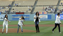 Kim Kardashian,left, Kourtney Kardashian , Khloe Kardashian and Kris Jenner,right, throw out the ceremonial first pitch prior to the Los Angeles Dodgers' baseball game against the Washington Nationals in Los Angeles, Wednesday, May 6, 2009. (AP Photo/Lori Shepler)