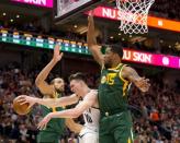 Mar 16, 2019; Salt Lake City, UT, USA; Brooklyn Nets forward Rodions Kurucs (00) attempts to pass the ball from between Utah Jazz center Rudy Gobert (27) and forward Derrick Favors (15) during the second half at Vivint Smart Home Arena. Mandatory Credit: Russ Isabella-USA TODAY Sports