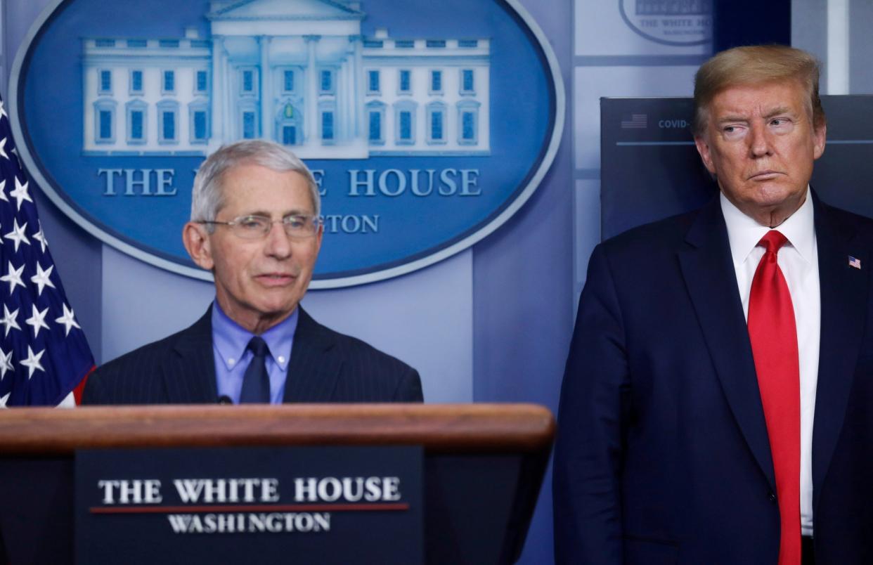Donald Trump eyes Anthony Fauci during an April coronavirus briefing: REUTERS