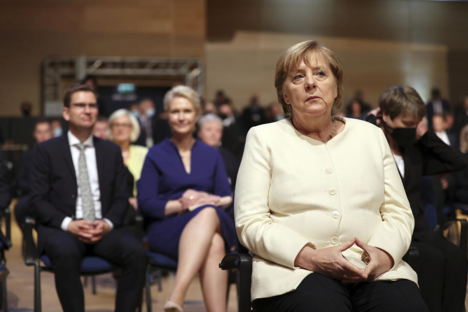 Federal Chancellor Angela Merkel (CDU) takes part in the ceremony marking German Unity Day in the Handel Hall in Halle/Saale, Germany, at the central celebrations for the Day of German Unity, Sunday, Oct. 3, 2021. (Hendrik Schmidt/Pool via AP)