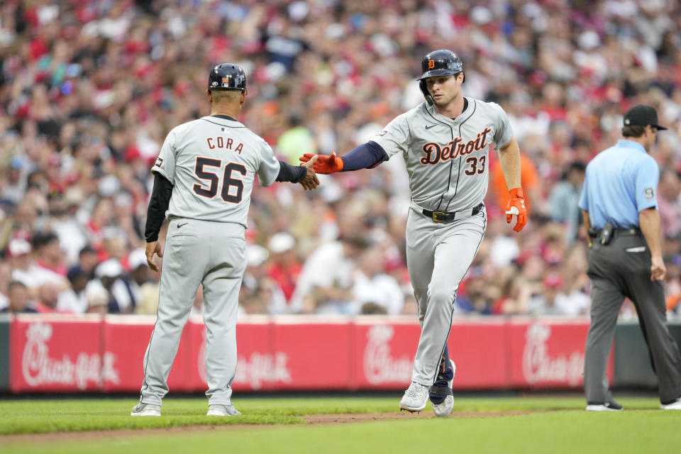 Detroit Tigers' Colt Keith (33) celebrates with third base coach Joey Cora (56) as he rounds the bases after hitting a solo home run in the third inning of a baseball game against the Cincinnati Reds in Cincinnati, Friday, July 5, 2024. (AP Photo/Jeff Dean)