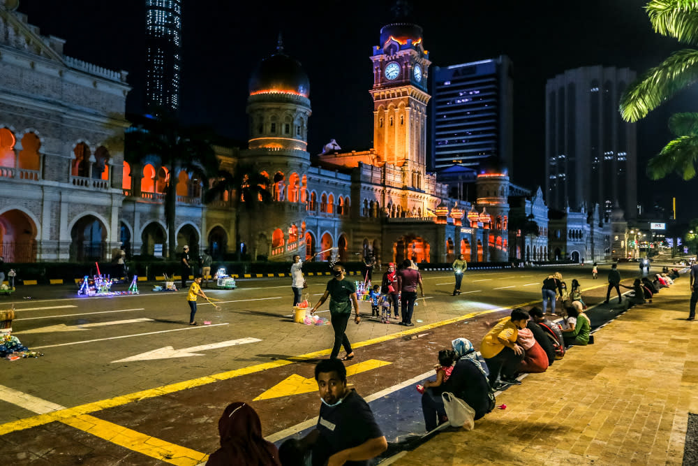 People wearing face masks are pictured at Dataran Merdeka during the conditional movement control order (CMCO) in Kuala Lumpur December 5, 2020. — Picture by Firdaus Latif